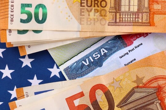 United States VISA in passport page with euro money bills on US flag close up. Entry tax to the US, visa fee tax, deposit euro upon entry to the USA - Powered by Adobe