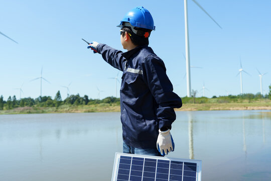Engineering technicians are working to check the operation of solar panels in wind farms and inspect the electricity.