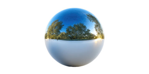 A perfectly spherical, reflective surface mirroring a beautiful landscape with trees and a clear blue sky