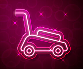 Glowing neon line Lawn mower icon isolated on red background. Lawn mower cutting grass. Vector