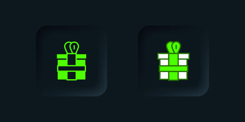 Obraz premium Green Gift box icon isolated on black background. Black square button. Vector