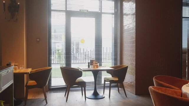 morning scene with chairs and view, serene breakfast setting with cityscape through large glass window
