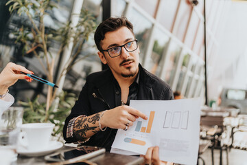 A team gathering outdoors analyzing business charts, emphasizing data trends and collaboration.