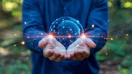 Person holding a glowing digital globe in their hands, representing technology and global connection