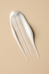 White Cream Smear on Beige Background
