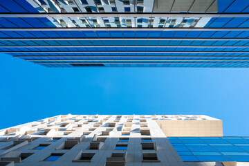 Glass facade structures show modern architecture enhanced by reflections, geometry, office buildings, corporate mood, contrast and clean lines in a strong contemporary look