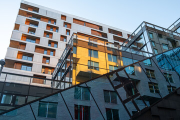 Corporate energy appears through modern architecture as reflections animate the glass facade, adding geometry, clean lines, contrast and office buildings in a bold visual design