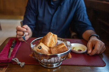 Man Dining with Fresh Bread Basket