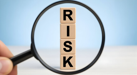 Analyzing risk management strategies with a magnifying glass to identify potential challenges and improve decision-making for successful business ventures.