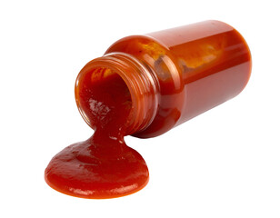 plastic bottle of red tomato ketchup sauce lying on side with thick sauce spilling out on isolated background