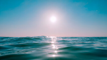 Fototapeta premium Sunlight reflecting on the ocean waves creating a beautiful and peaceful scene on a sunny day