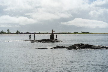 Fishermen on the Rocks and Boat in Itacaré Bahia Brazil