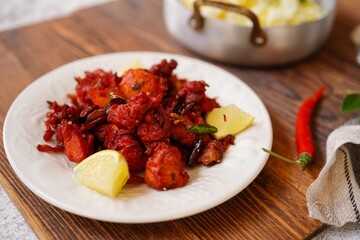 Homemade Chicken 65 - Popular Indian bar ppetizer  served with saffron rice