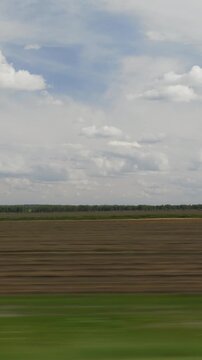 sunny day time plowed harvest field landscape road trip passenger side window pov vertical panorama 4k