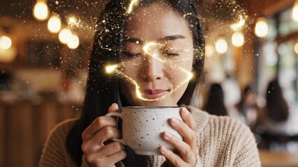 Asian woman in cafe enjoys sparkling magical drink from cup. Glowing beverage creates enchanting facial reaction with bliss. Cozy atmosphere footage for beverage advertising concept.