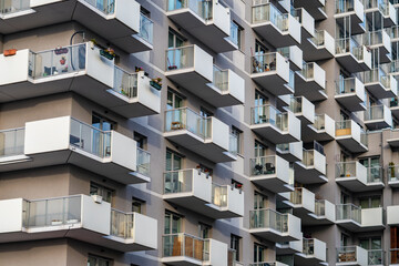 Modern residential building facade with metal modular balconies in a geometric layout within a contemporary architecture estate