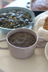 Bowls and bags full of various healthy grains and legumes. Selective focus.