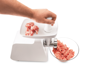 Hand using an electric meat grinder to process raw meat into ground mince, isolated on a transparent background