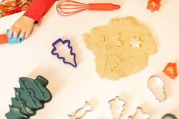 Children enjoy making holiday cookies with fun shapes and colors in the kitchen during a festive afternoon