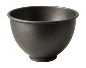Durable iron mixing bowl, ideal for whisking eggs in a charming country kitchen.