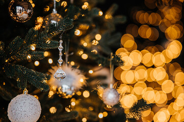 Festive decoration scene, Elegant holiday ornament setup, Bright glass ornament with festive lighting ambiance, Decorative glass piece hanging on pine branch with glowing lights