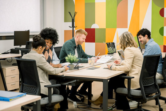 Diverse business team collaborating during productive meeting in modern office