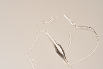 Close-up of a creamy cosmetic gel texture featuring smooth, flowing lines. The soft beige color and minimalist aesthetic create a soothing, elegant visual.