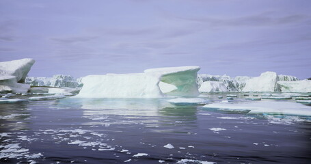 Majestic icebergs drift smoothly in tranquil waters, surrounded by glacial landscapes under a clear blue sky. This serene polar habitat showcases natures beauty and solitude. © icetray