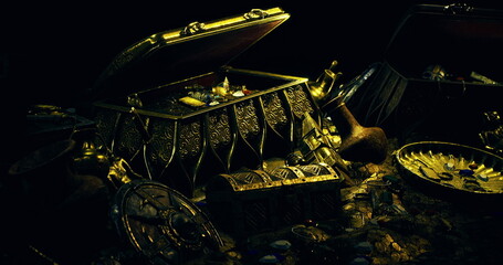 An ornate treasure chest is open, revealing an array of gold coins, sparkling gemstones, and intricate artifacts. Shadows enhance the allure of this hidden bounty. © icetray