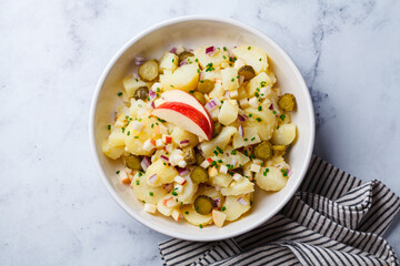 Traditional German potato salad with pickles, onions and apple.