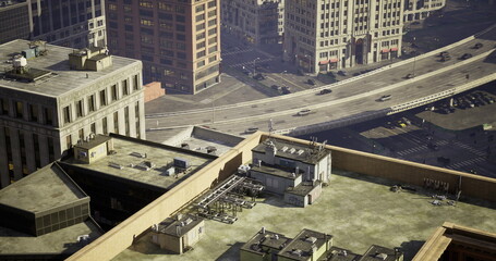 A high angle view from a rooftop in a bustling urban area captures cars traveling on a busy highway below. Surrounding buildings reflect the cityscape under bright daylight.