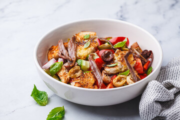 Italian panzanella with anchovies, olives and tomatoes.