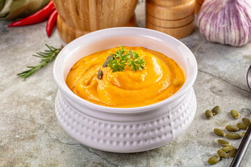 Tasty pumpkin cream soup served seeds