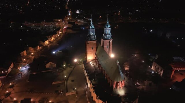 Aerial Gniezno Poland cathedral cityscape night fly away 4K. Since 1000 AD, it has been the main church of the Gniezno. Basilica of the Assumption of the Blessed Virgin Mary or the Sanctuary.