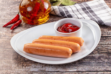 Boiled sausages with ketchup