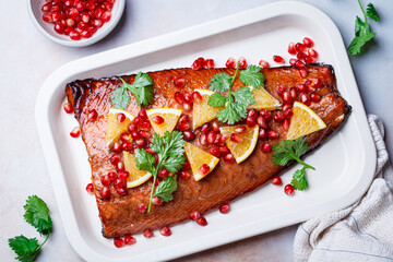 Christmas salmon in pomegranate juice with orange and pomegranate seeds.