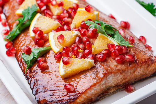 Christmas salmon in pomegranate juice with orange and pomegranate seeds.