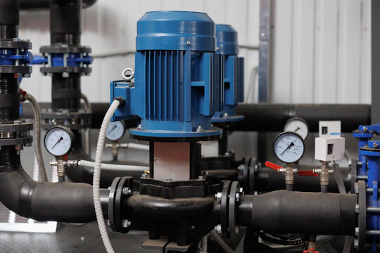 Modern pump system with blue motors and gauges operating in an industrial setting