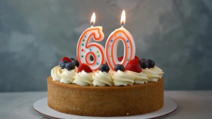 Decorated cake with candle in number 60. Video for birthday or anniversary party and celebration