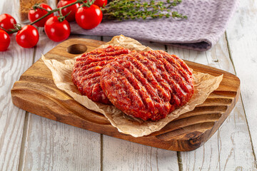 Raw uncoocked red beef round cutlet