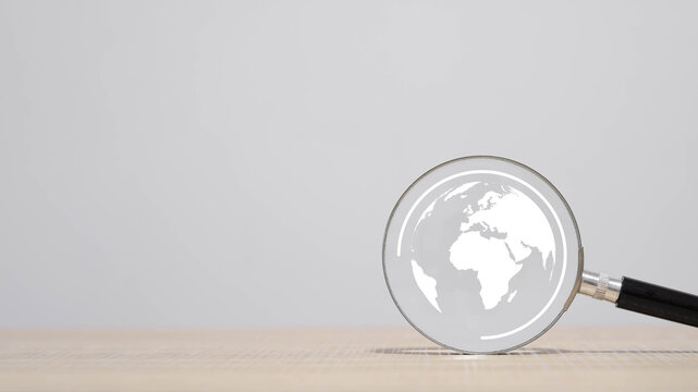A magnifying glass focusing on a world map symbolizing global search, analysis, and international research, ideal for business strategy, data exploration, and worldwide discovery concepts.