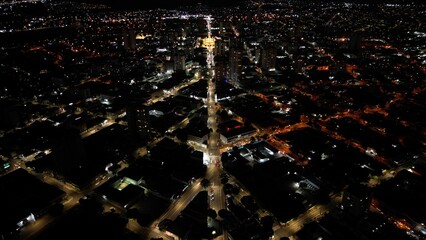 Aerial night view of a city with illuminated streets and buildings. Urban, architecture, night. Perfect for travel, tourism, commercial themes.