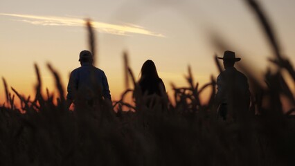 three farmers wheat field raised their hands up, agriculture, Farmers celebrating bountiful wheat harvest, Silhouetted figures golden wheat field sunset, Community spirit among farmers rural landscape
