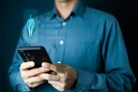Businessman hand hold phone checking biometric vitals on phone with futuristic screen showing heart rate data human anatomy and digital health information for monitoring and fitness tracking