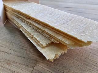 Long potato chips. Crispy, thin potato snack, rectangular strips of chips