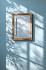 Wooden frame on pastel wall with artistic shadow play for stylish interior mock up