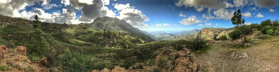 Scenic mountain landscape in a sunny panorama with clouds and sky