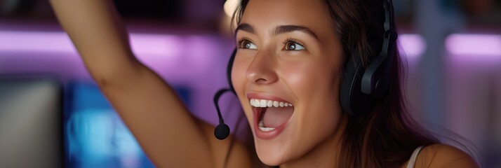 Excited young female gamer celebrating victory with headset