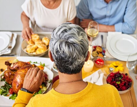 A delightful family gathering enjoying a festive holiday dinner with roasted chicken and various - Powered by Adobe