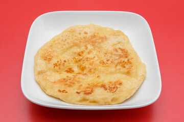 Chapati – pain traditionnel indien et sri-lankais. Fond rouge. 